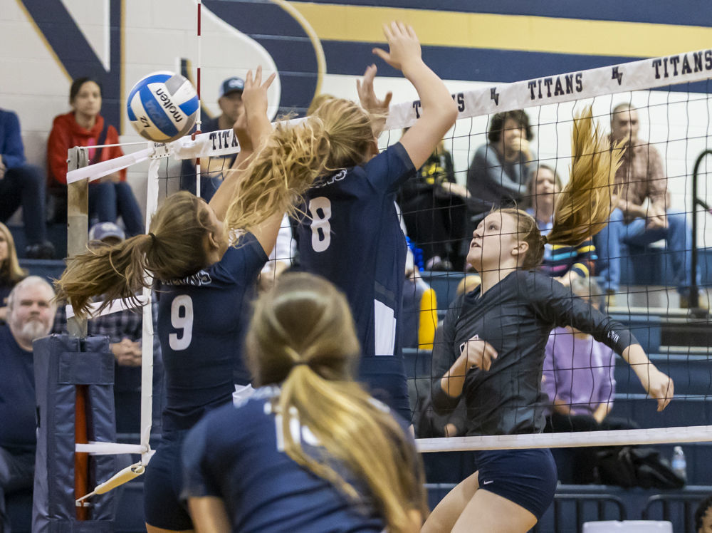 Hidden Valley's (13) Cam Davenport gets the ball past Abingdon's (9) Katie Harless and (8) Alexis Brown.